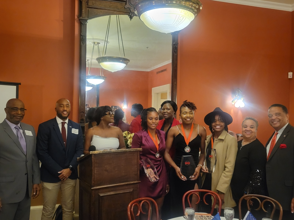 Award presentation at podium, 2023 gala