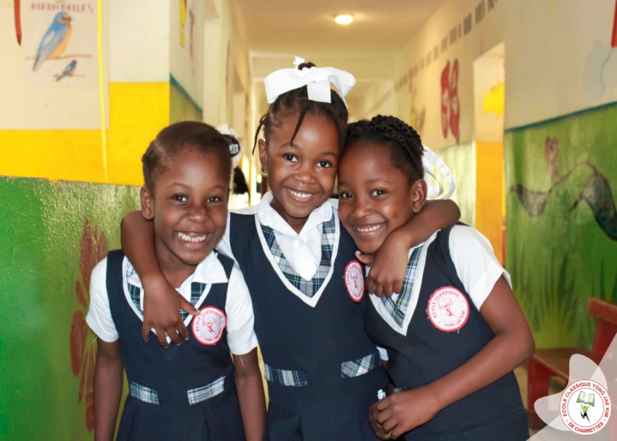 Three smiling Haitian girls at MHFC