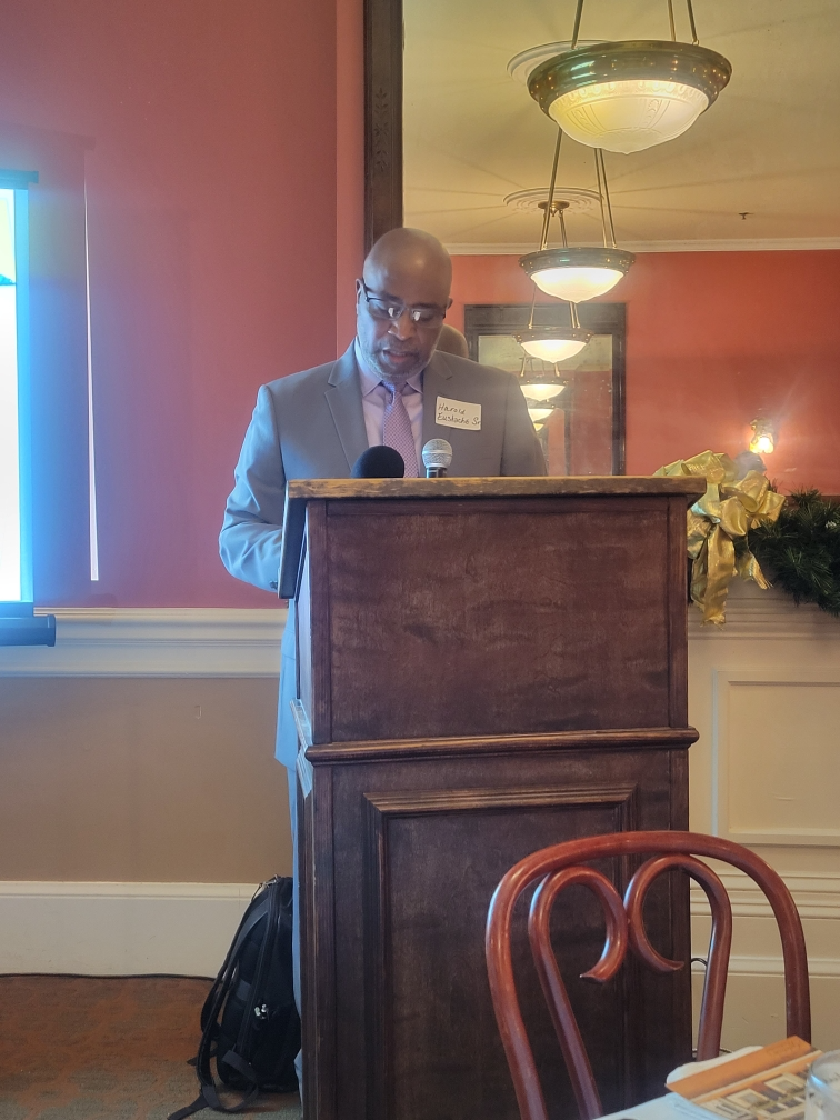Speech at podium, Haiti women's soccer event